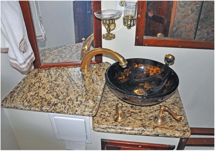 The pièce de résistance in the refurbished head is the tempered-glass washbasin complemented by the polished-brass faucet set.