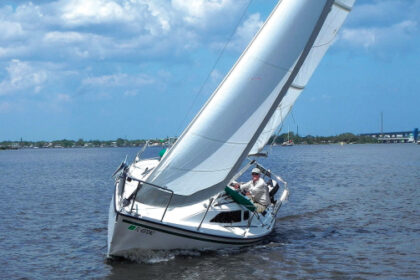 Kim Hogan shows off the sharp lines and sparkling flat-water performance of Willow, his Precision 23, on the St. Lucie River on Florida’s east coast, top of page.