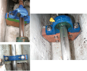 Dave taped everything he did not want to get epoxy on, top left. The marks on the hull indicate where the wooden block had to be to avoid distorting the shaft. The epoxy filled a wedge-shaped space, bottom left. A smear of grease helps keep salt water out, at left.