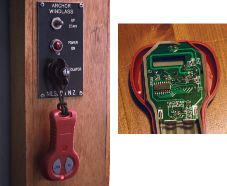 Darren stores his windlass remote near the fixed windlass controls, where he can easily see if the remote has been left on, far left. The isolator switch is normally left off and the windlass can’t be inadvertently operated unless it and the remote (or the fixed switch) are activated. The bungee-cord wrist strap on the remote reduces the chance of it falling overboard. As delivered, the remote was not watertight, as the gasket that seals the remote was pinched under the circuit board, at left. After Darren refitted the gasket, the remote passed his immersion test, although he says he considers it to be rain-resistant rather than waterproof or submersible.