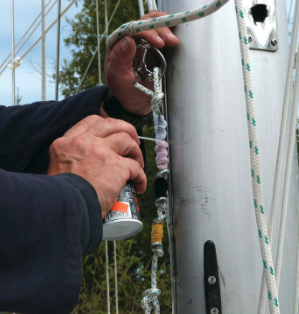 Applying sail coat to the pipe cleaner tool