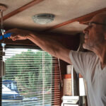 One of Dean’s morning rituals is removing the spiderwebs that festoon the boat inside and out, above. Dean pinched his Swiffer Duster from Charlotte, his wife. The design has since changed but he manages to force the new refills onto his old handle.