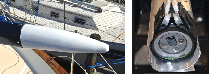 Roger fashioned yard ends out of cedar blocks and painted them traditional white, at left. They are removable so he can access the rope winch driver, at right, that turns the mandrel inside the yard at one end and the thrust bearing and tension adjuster at the other.