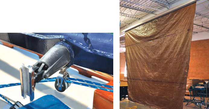The gooseneck, at left, is a rather intricate affair as it has to allow the yard to rotate in several directions for sailing or stowing in a marina-friendly manner. Roger tested the furling system in his daughter’s warehouse, at right, with a sail made from a plastic tarp.