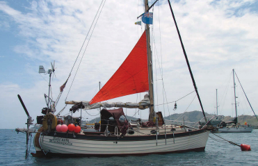 When sheeted on the centerline, the trysail sets a little higher on the mast to obtain optimum sail shape. Ed and Ellen set the sail in this position in moderate wind conditions. The boom can be lashed securely either in the center notch of the gallows or to either side, depending on the requirements at the time.