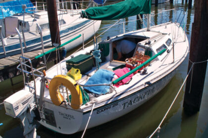 The boat Tackful anchored at dock
