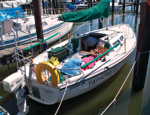 The boat Tackful anchored at dock