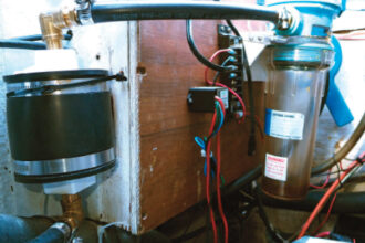 Cliff’s burp catcher, at the right in the photo, has been doing its job of trapping diesel fuel. The dryer, at the left, is between the burp catcher and the vent in the transom.