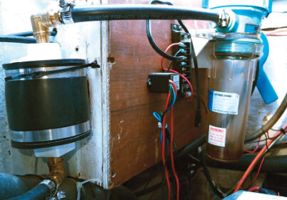 Cliff’s burp catcher, at the right in the photo, has been doing its job of trapping diesel fuel. The dryer, at the left, is between the burp catcher and the vent in the transom.
