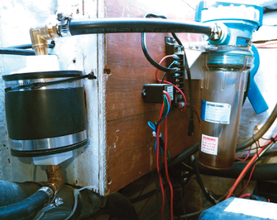 Cliff’s burp catcher, at the right in the photo, has been doing its job of trapping diesel fuel. The dryer, at the left, is between the burp catcher and the vent in the transom.