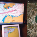 Menachem uses three navigation platforms on his boat, above. Google Earth images, like this one, of an anchorage near Agios Spiridon, Greece, are also helpful, at right.