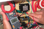 David measures voltage with a multimeter, top of page. The one he’s using has a current clamp that allows him to measure current without disconnecting wires.
