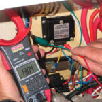 David measures voltage with a multimeter, top of page. The one he’s using has a current clamp that allows him to measure current without disconnecting wires.
