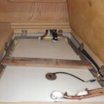 When the leaking aluminum water tank rebuffed Alan’s attempts to remove it, he placed a new polypropylene tank inside it.