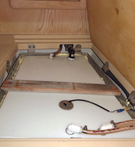 When the leaking aluminum water tank rebuffed Alan’s attempts to remove it, he placed a new polypropylene tank inside it.