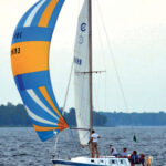 Underdog races frequently on Michigan’s Bay of Green Bay, at top. Here, she’s flying a spinnaker that dates to her days as Vagus.