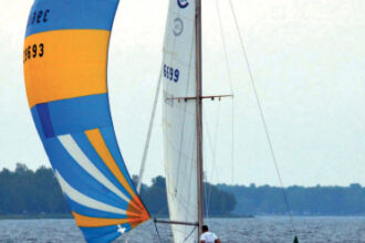 Underdog races frequently on Michigan’s Bay of Green Bay, at top. Here, she’s flying a spinnaker that dates to her days as Vagus.