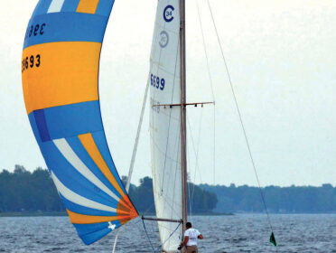 Underdog races frequently on Michigan’s Bay of Green Bay, at top. Here, she’s flying a spinnaker that dates to her days as Vagus.