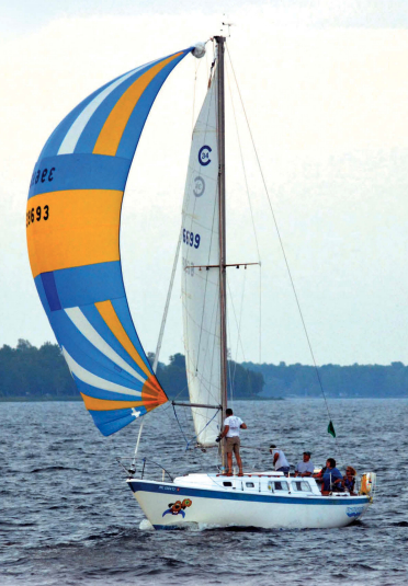 Underdog races frequently on Michigan’s Bay of Green Bay, at top. Here, she’s flying a spinnaker that dates to her days as Vagus.