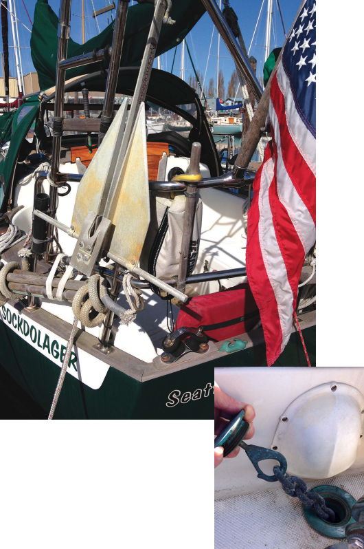 On small boats, storage space is at a premium, but with a little creativity you can still find a spot for a stern anchor, above. This lightweight Fortress has good holding power and is stored in a bracket mounted to the stern pulpit and just above the rolled-up rope-and-wood swim ladder. Stern rollers are mounted at the port and starboard rail corners, for use in anchoring, warping, docking, or when towing a drogue to slow down in heavy weather at sea. A 200-foot stern anchor rode is stored in a locker just aft of the tiller, at right. Jim cut the hole, epoxied the hook under the screw-on lid, and built a bulkhead underneath to contain the rode. This was previously unused space.
