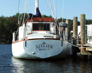 The transom view shows the split backstays. The wheelhouse provides a convenient place to carry propane tanks.