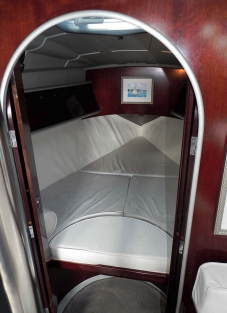 The sides of the forward cabin are padded for comfort, at right. Elements of the styling revolution are evident in the dark acrylic storage compartments, the aluminum door frame, and the faceted overhead liner.