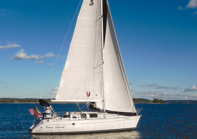 Jim and Jessica McCann sail their trendsetting Beneteau First 32s5, Down Island, on lakes in Kentucky and Tennessee, above.