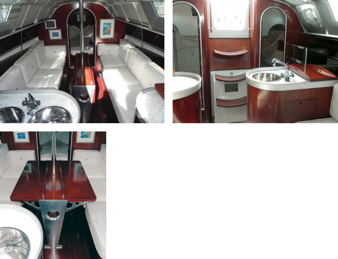 The Philippe Starck interior shocked Americans with its modern white and metal elements, above left. The head (to starboard) and the aft cabin (to port) flank the companionway, above right. The tray on the galley counter covers the second sink. Philippe Starck’s saloon table, at left, appeals to the eye of the engineer and that of the artist.