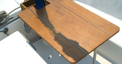 The table makes dining in the cockpit a pleasure. The added condiment box is convenient for bottles, napkins, utensils, and (of course) condiments.