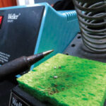 Tinning the tip of the soldering iron is crucial to making good solder joints. The sponge, kept damp, is used for cleaning the tip.