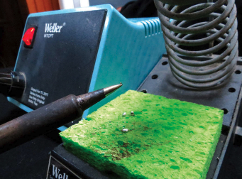 Tinning the tip of the soldering iron is crucial to making good solder joints. The sponge, kept damp, is used for cleaning the tip.