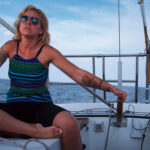 Once she discovered sailing, Lisa, here at the helm of Escape, found it brought back fond memories of time spent on the water with her father.