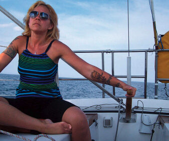 Once she discovered sailing, Lisa, here at the helm of Escape, found it brought back fond memories of time spent on the water with her father.