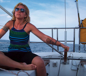 Once she discovered sailing, Lisa, here at the helm of Escape, found it brought back fond memories of time spent on the water with her father.
