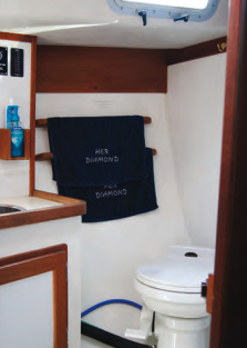 The head compartment is fitted with a VacuFlush toilet that uses fresh water.