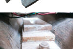 The original mast step was in dire shape, top of page, as the result of years in contact with stainless-steel keel bolts. The G-10 replacement, while not pretty after two years in the bilge, is still intact, at left.