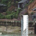 Jerry Powlas wanders down the jetty in front of Lin and Larry Pardey’s hillside home on Kawau Island, New Zealand.