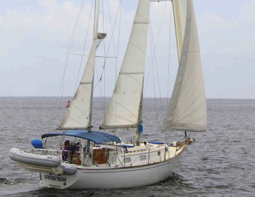 A low-aspect, well-balanced sail plan enables the Pearson 365 ketch to stand up in a blow, above. Lindsey Sailors, at left, and her husband, Don, command their Schurr Thing from an elevated custom swiveling helm seat.