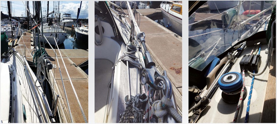Chest-high lifelines (actually waist-high at the cockpit) act like railings and can be clipped onto with a safety harness, left. A D-ring seized to the shroud acts as a guide. The aft end of the chest-high lifeline has a pelican hook that clips into a ring attached to the stern pulpit with Spectra loops, center. A piece of Rescue Tape rolled into a rubbery band is rolled over the opening part of the pelican hook for safety. The main halyard (red), topping lift (blue), and boom vang control (middle) are led back to the cockpit, right. The staysail sheet is to the far left. Tails of lines that are not being used are stowed in a small canvas bag lashed to the dodger strut.