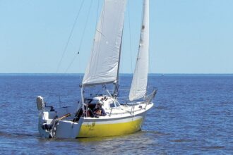 A view from the quarter shows the marked flare toward the bow that created a broad foredeck on the narrow hull.