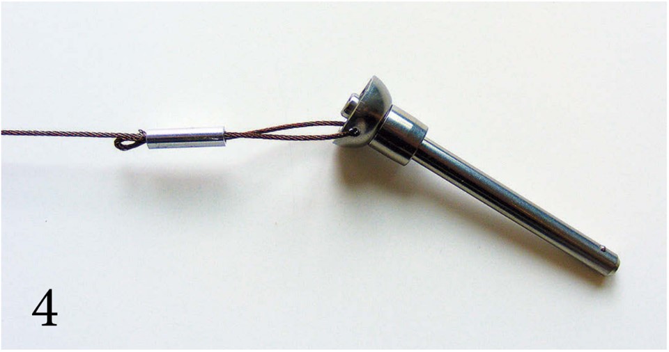 Push and pull the wire to adjust the loop lengths (PHOTO 4). The small loop to the left will help keep the wire from pulling through the sleeve.