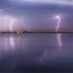 Photo of a lightning storm over water