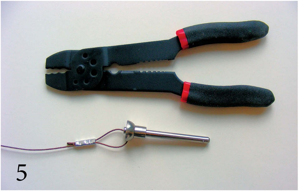 Crimp the sleeve around the leader wire (PHOTO 5). The crimping can be done with any kind of squeezing tool.