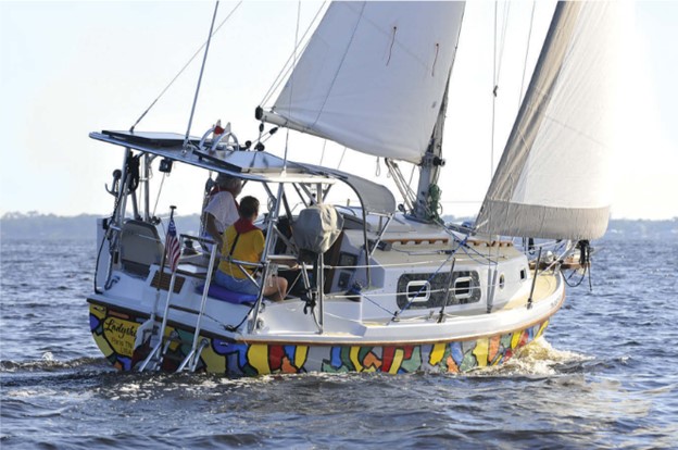 Rob has made a great many modifications to Ladyship, including the “hard Bimini” with solar panels, upholstered helm seats, swim ladder, and opening portlights.