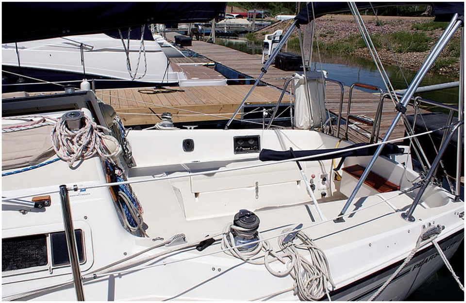 High coamings and seats that are long enough to lie down on make for a comfortable cockpit. The engine controls are on the starboard side.