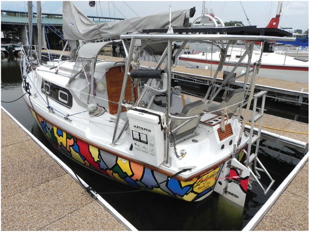 The Pageant’s cockpit seats are quite low, so Rob installed elevated padded helm seats port and starboard to allow a better view over the high cabin. Rob replaced the original rudder with a transom-hung rudder and steers with a vertical tiller that swings from side to side between the seats.