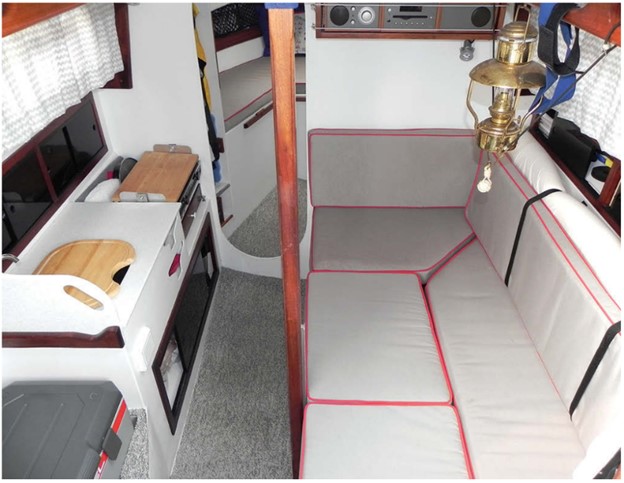 The dinette on the starboard side of the saloon converts to a berth. The port side is a small galley. Rob fitted an Engel cooler/freezer aft of the galley.