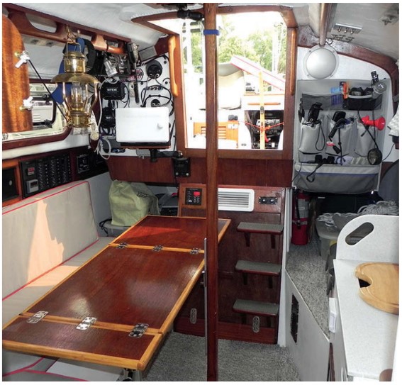 Rob’s excellent workmanship is evident in the three-piece table that folds up as needed and the varnished trim. He found space to mount more electronics than the minesweeper he served on ever saw.