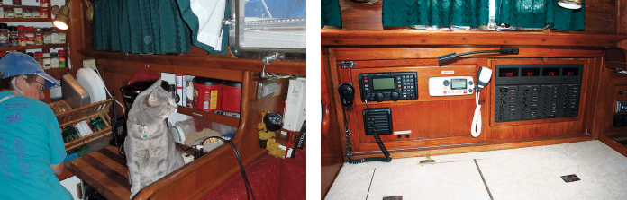 Gwyn works in the compact galley with Joshua, at left, who joined the crew as a rescue kitten soon after Ron and Gwyn bought Rapport. Refrigeration is on the starboard side. Ron built the new Bass electrical panel, at right, to replace the original panel, which was barely accessible and difficult to read. The side-by-side radios are an ICOM-M802 SSB (which receives GRIB weather data) and a West Marine VHF radio.
