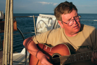A picture of a man playing the guitar